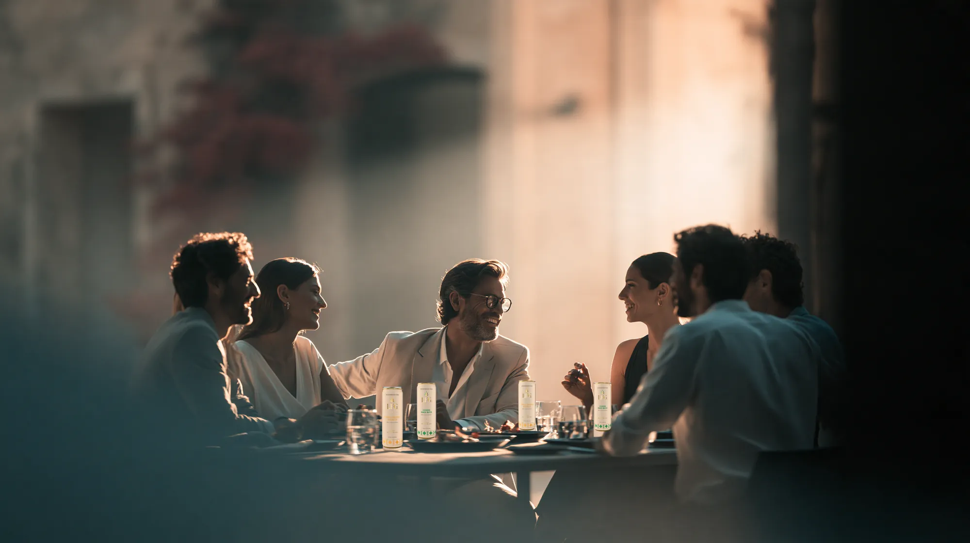 Friends sharing dinner with LFG cans on the table